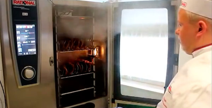 Steam coming out of a SelfCookingCenter, chef watching.