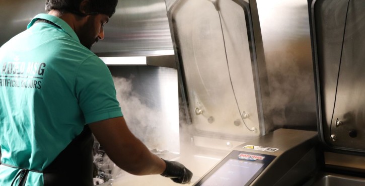 Chef cooking with RATIONAL iVario Pro tilting pan in a professional kitchen.