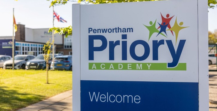 Penwortham Priory Academy welcome sign outside the school building.