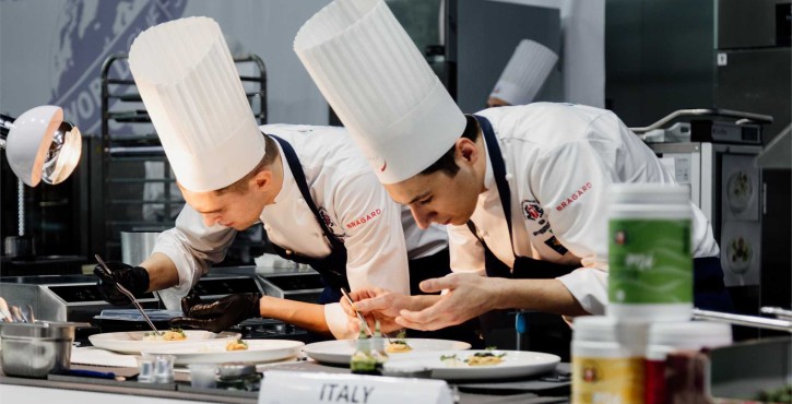Chef demonstrating RATIONAL combi oven to audience at World Chefs Congress 2026