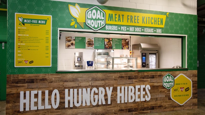 Goal Mouth meat-free kitchen counter with menu boards and Hibernian branding.