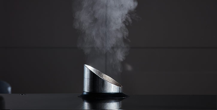Steam erupts out of a combi-steamer pipe.