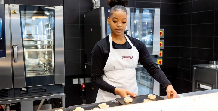 A young female chef prepares pastries to go into the iCombi Pro oven