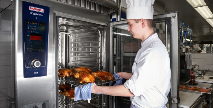 A chef takes out some juicy roast chickens from the iCombi Pro combi steam oven.