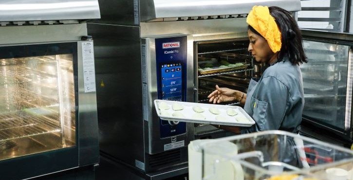 Chef placing pastry tray into the RATIONAL iCombi Pro combi oven.