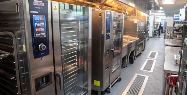 Row of RATIONAL iCombi Pro combi ovens installed in a modern professional commercial kitchen.