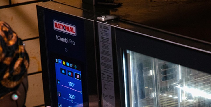A close-up of the control panel of a Rational iCombi Pro oven, showing the digital display and settings.