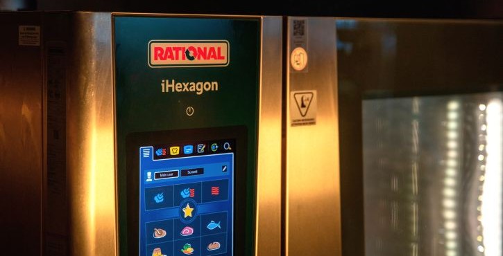 Close-up of a RATIONAL iHexagon combi oven control panel in a commercial kitchen.