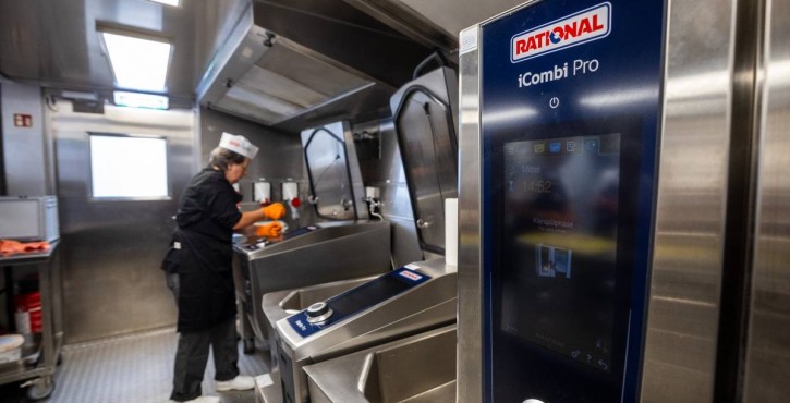 RATIONAL iCombi Pro combi oven in foreground with iVario Pro units and chef working in background.