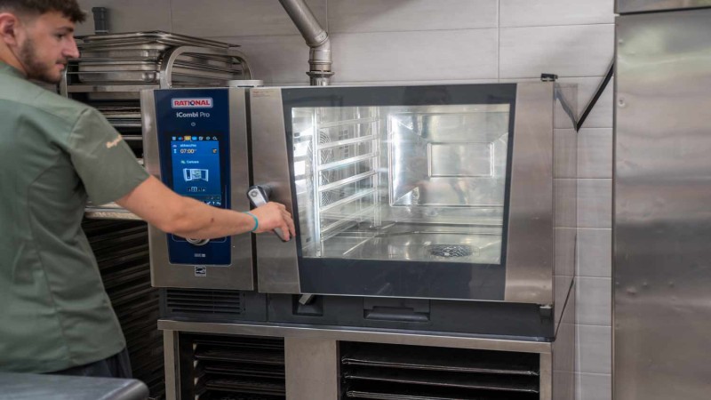Chef utilizza un RATIONAL iCombi Pro forno professionale in una cucina professionale.