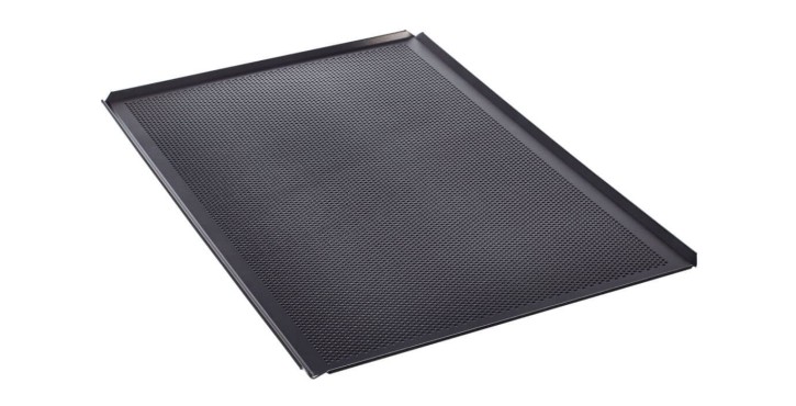 A perforated black baking tray designed for professional baking, ensuring optimal heat circulation for even cooking.