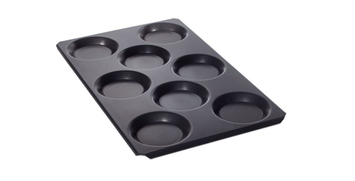 Baking tray with eight circular indentations for muffins or pastries.