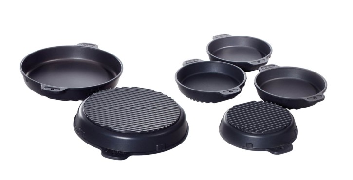 Assorted roasting and baking pans, including smooth and ribbed surfaces, in various sizes.