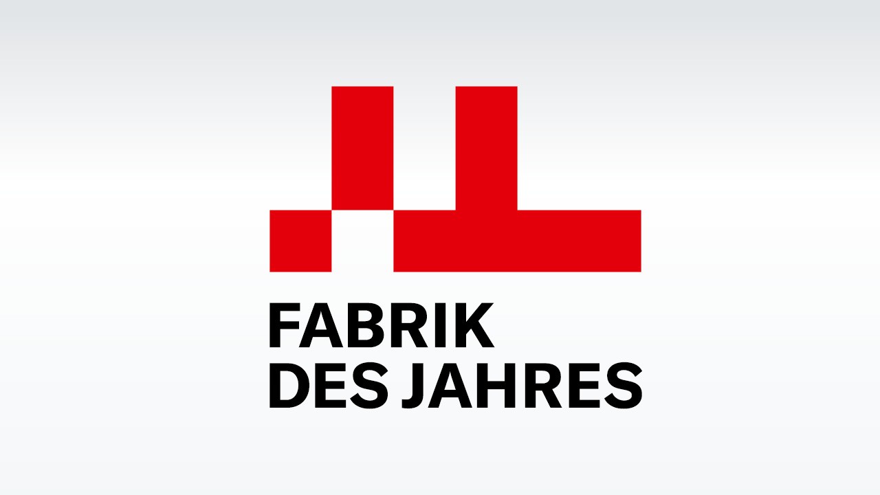 赤い工場風グラフィックと太字の黒文字を組み合わせたFabrik des Jahres賞ロゴ。