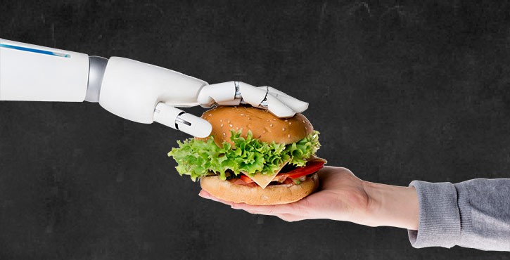 Robot hand passing a burger to human hand.