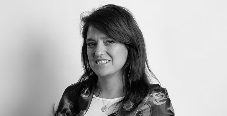 Portrait of Gisela Ciancio, smiling with shoulder-length hair.