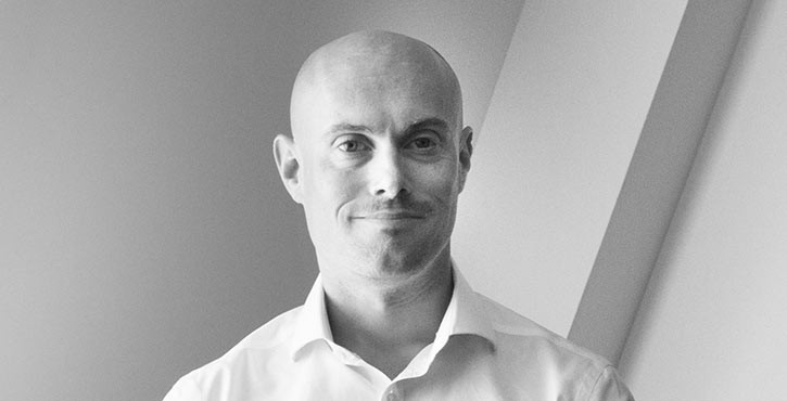 Black and white portrait of Michael Jones, looking kindly at the camera.