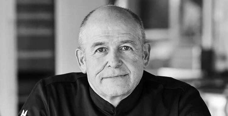  Black and white portrait of Oliver Fischer, looking straight at the camera.