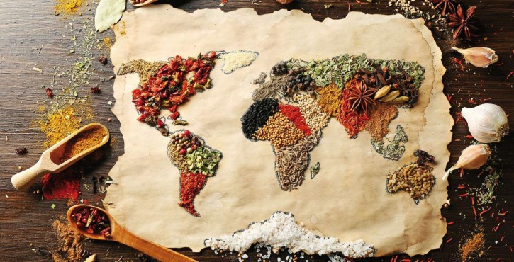 World map created with various spices on brown parchment.