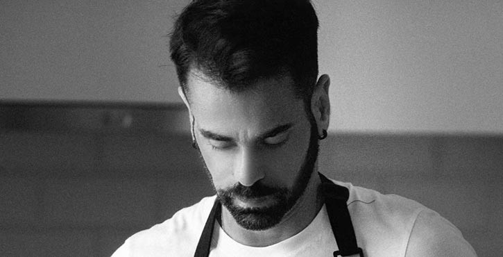 Portrait photo of Tim Vasilakis looking down with a focused expression.