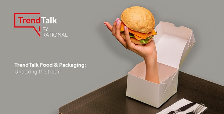 Hand holding burger emerging from an open box. Text: 
