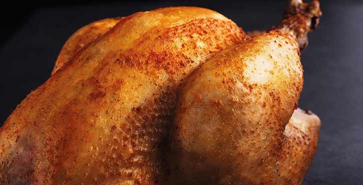 A beautifully grilled whole chicken with a crispy skin, seasoned with spices and ready to serve.