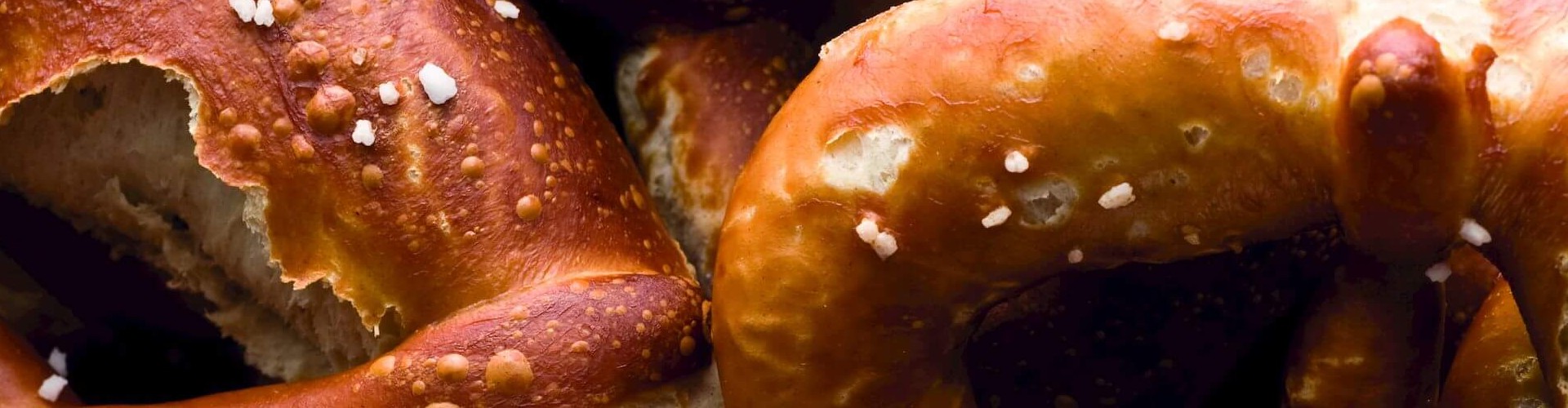 Close-up of warm, golden-brown salted pretzels.