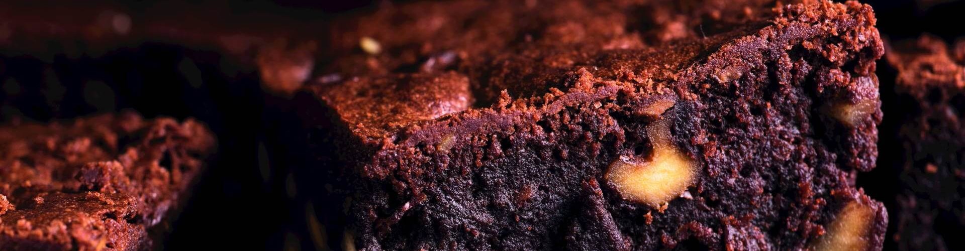 Close-up of a chocolate brownie with visible nuts.