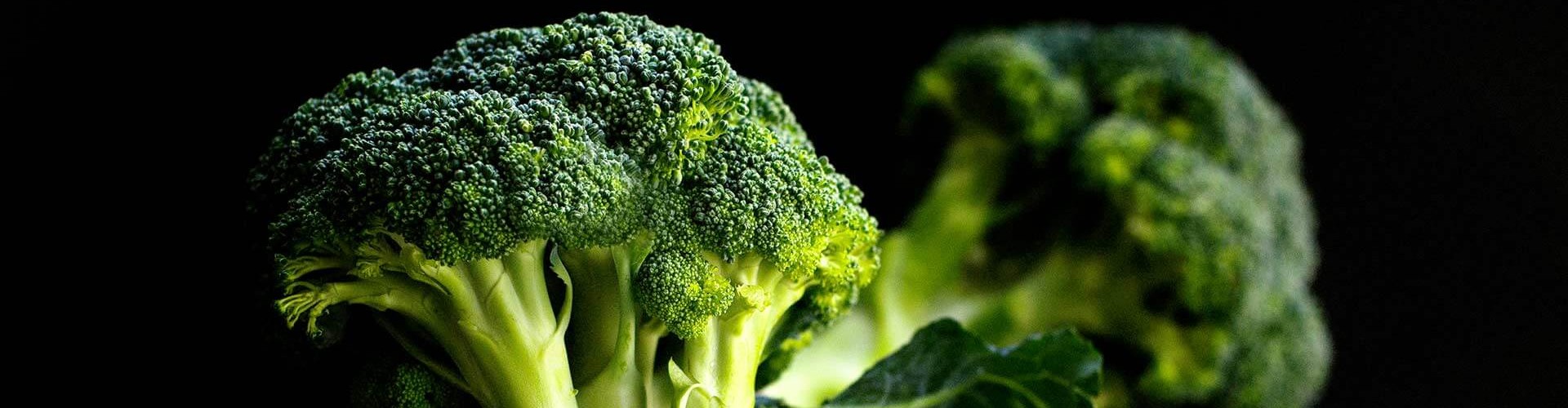 Una ciotola piena di broccoli freschi su uno sfondo scuro, che ne mette in risalto il colore verde vibrante e la consistenza.