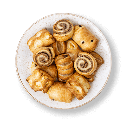 Plate of assorted pastries including sweet rolls and puff pastries.