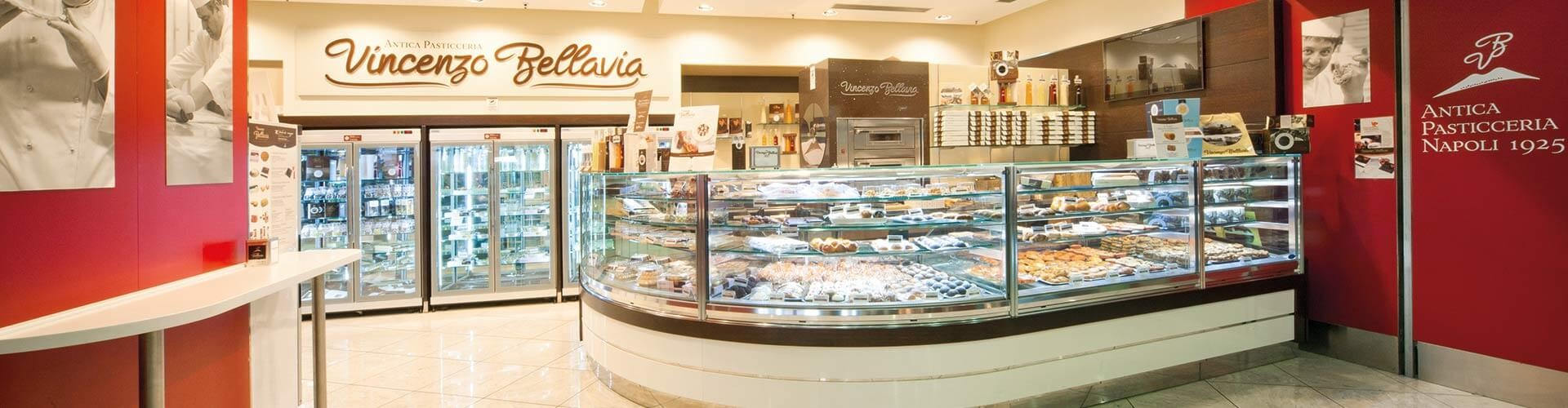 Wide view of the Vincenzo Bellavia pastry shop showcasing an array of desserts and pastries in a glass display.
