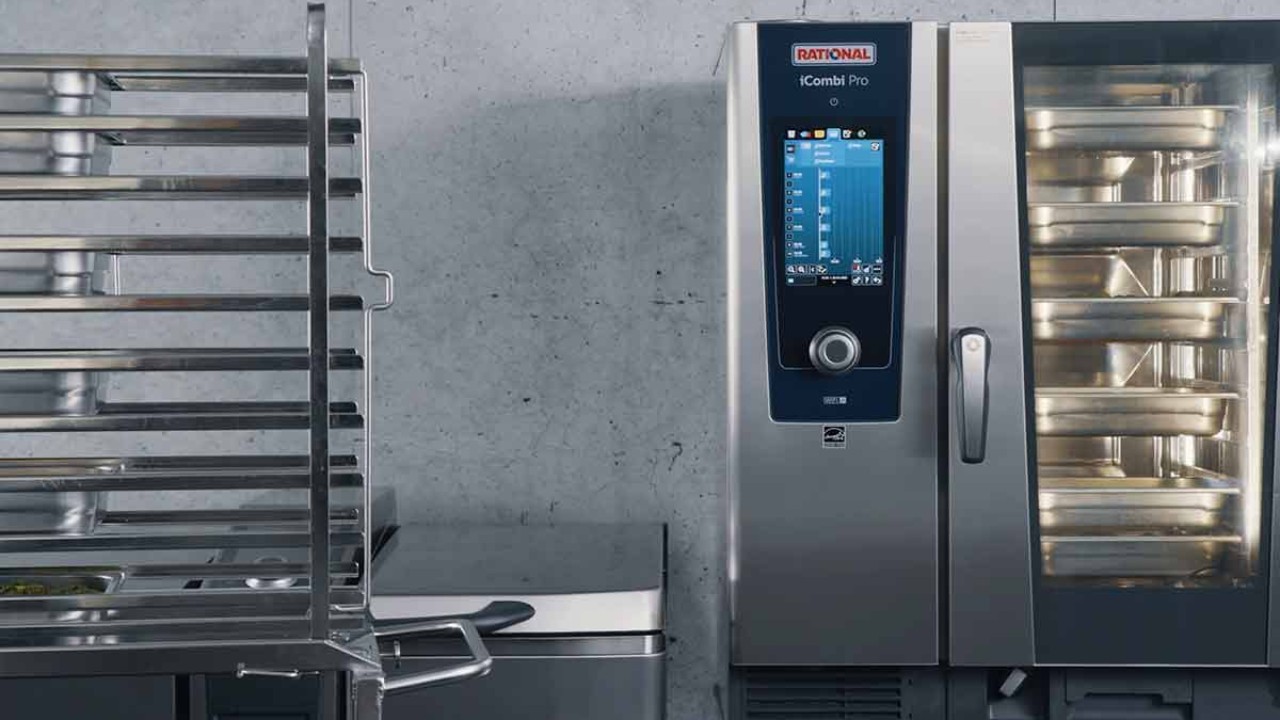 RATIONAL iCombi Pro combi oven with full tray rack beside it.