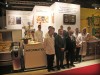 A 2009 trade show photo featuring a group of chefs and representatives standing in front of a display showcasing cooking equipment, with promotional signage in German.