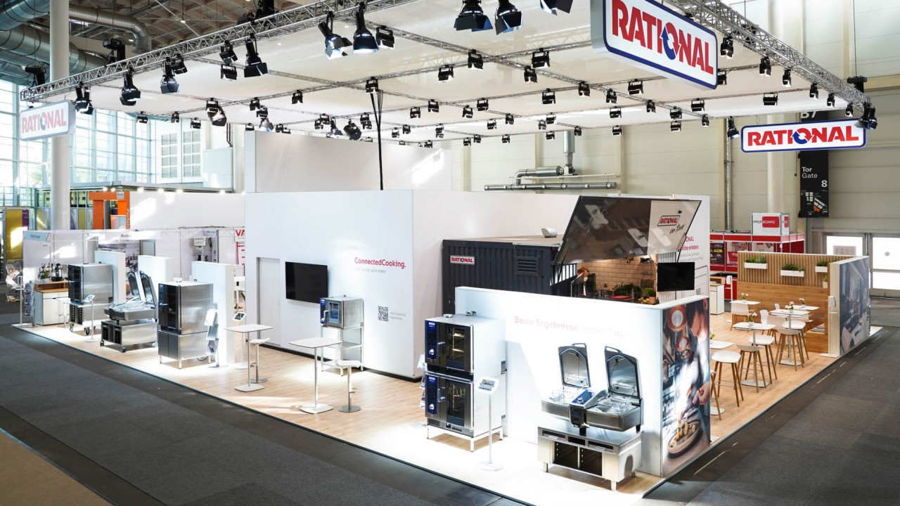 A modern exhibition booth for Rational at the Internorga trade show in 2022, featuring cooking equipment, displays, and seating areas.