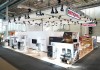 A modern exhibition booth for Rational at the Internorga trade show in 2022, featuring cooking equipment, displays, and seating areas.