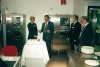 A celebration at the opening of a subsidiary company in 1991, with a cake and attendees in formal attire near Rational ovens.