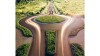 Aerial view of a circular road junction with two people walking towards the horizon.