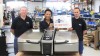 Three men in a factory setting pose with a Vario cooking appliance, celebrating the production of the 50,000th unit.