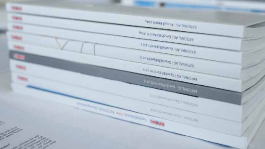 A stack of annual reports from Rational AG, neatly arranged with the spines facing outward, displaying the year 2014.