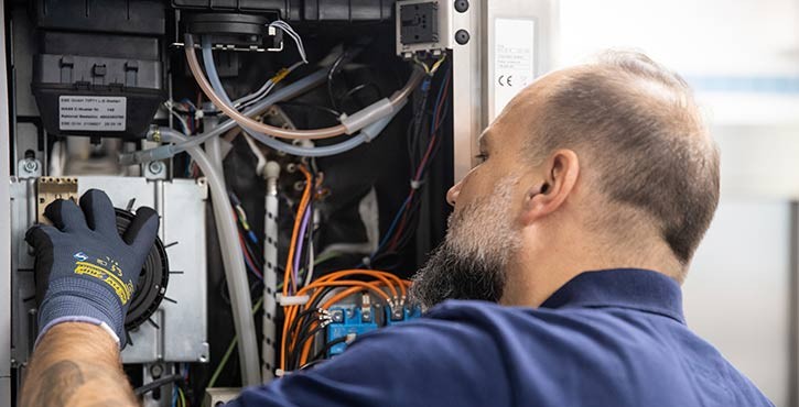 Technician works on the internal components of a Rational iCombi Pro.