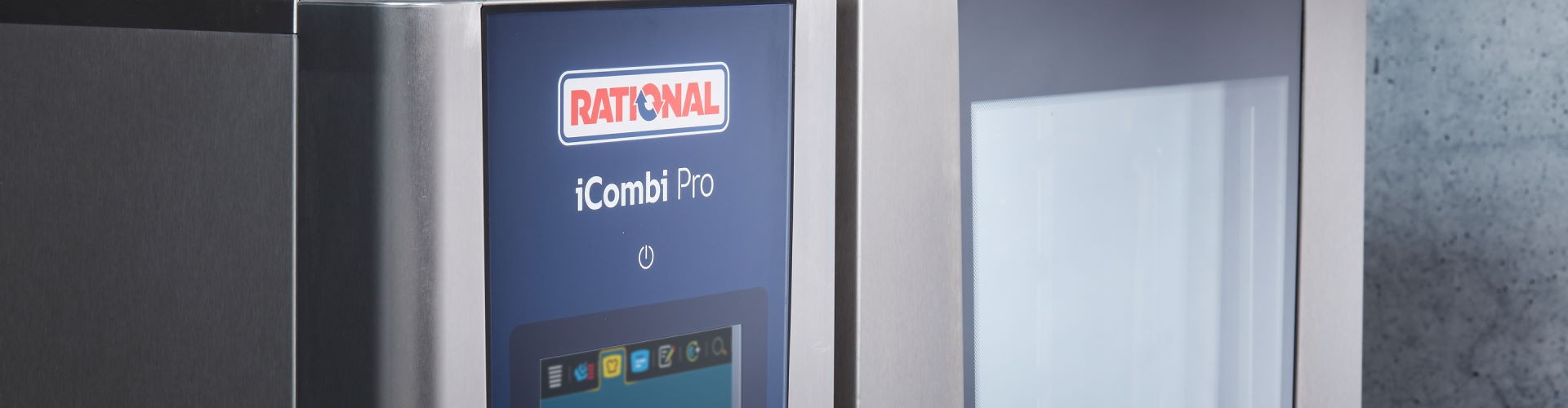 Hand operating touchscreen of RATIONAL iCombi Pro combi-steamer with cooking settings visible.