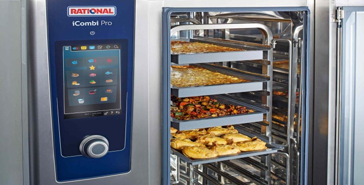 The Rational iCombi Pro with a cleaning phase displayed on the screen, showing water and cleaning agents on the glass door.