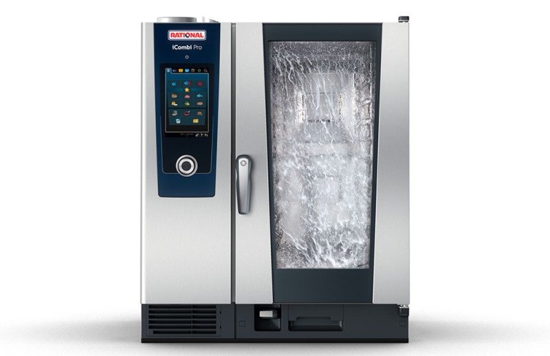 The Rational iCombi Pro with a cleaning phase displayed on the screen, showing water and cleaning agents on the glass door.