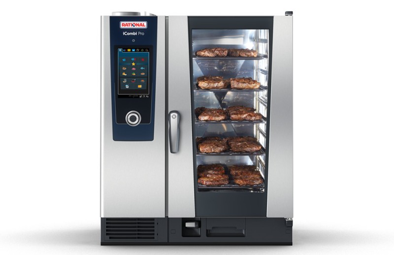 A Rational iCombi Pro oven filled with perfectly cooked steaks on multiple racks, showcasing the cooking process through its glass door.