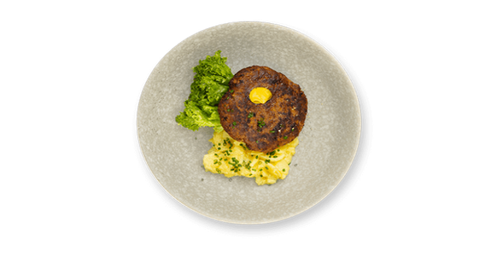 Grilled meat patty with mashed potatoes, broccoli, and a dollop of butter on a grey plate.