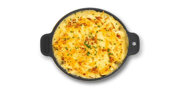 Mac 'n' Cheese with a golden cheese topping, garnished with chives.