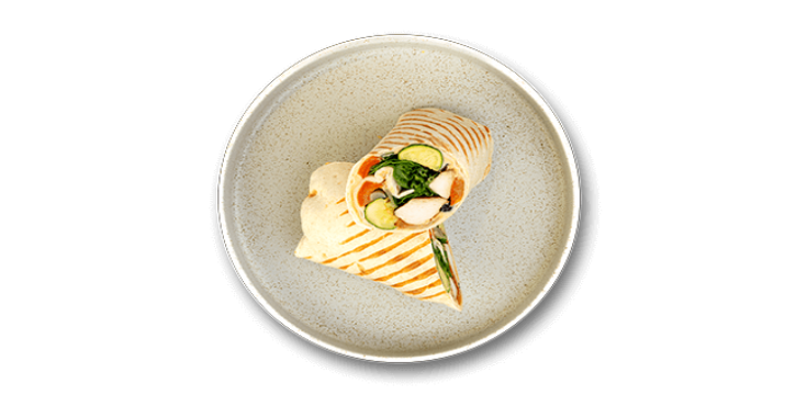 Grilled wrap with chicken, cucumber, and greens on a grey plate.