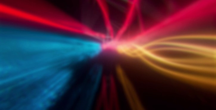 Abstract energy flow with blue, red, and yellow light trails converging towards the center.