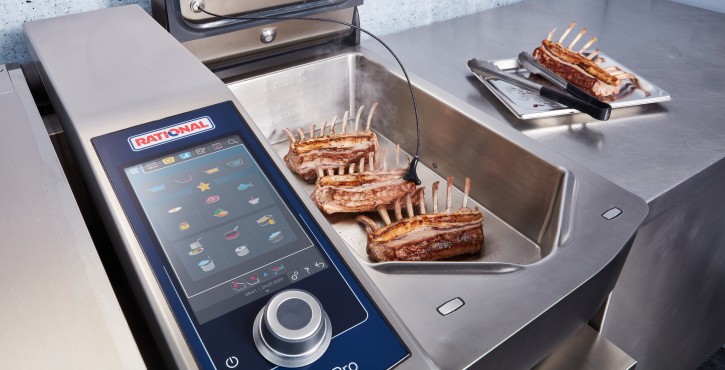 A close-up of the iVario Pro XL with lamb ribs being roasted, featuring a core probe for temperature monitoring.