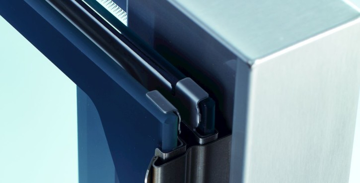 Close-up of the hinge mechanism of an iCombi Pro door with triple glazing.